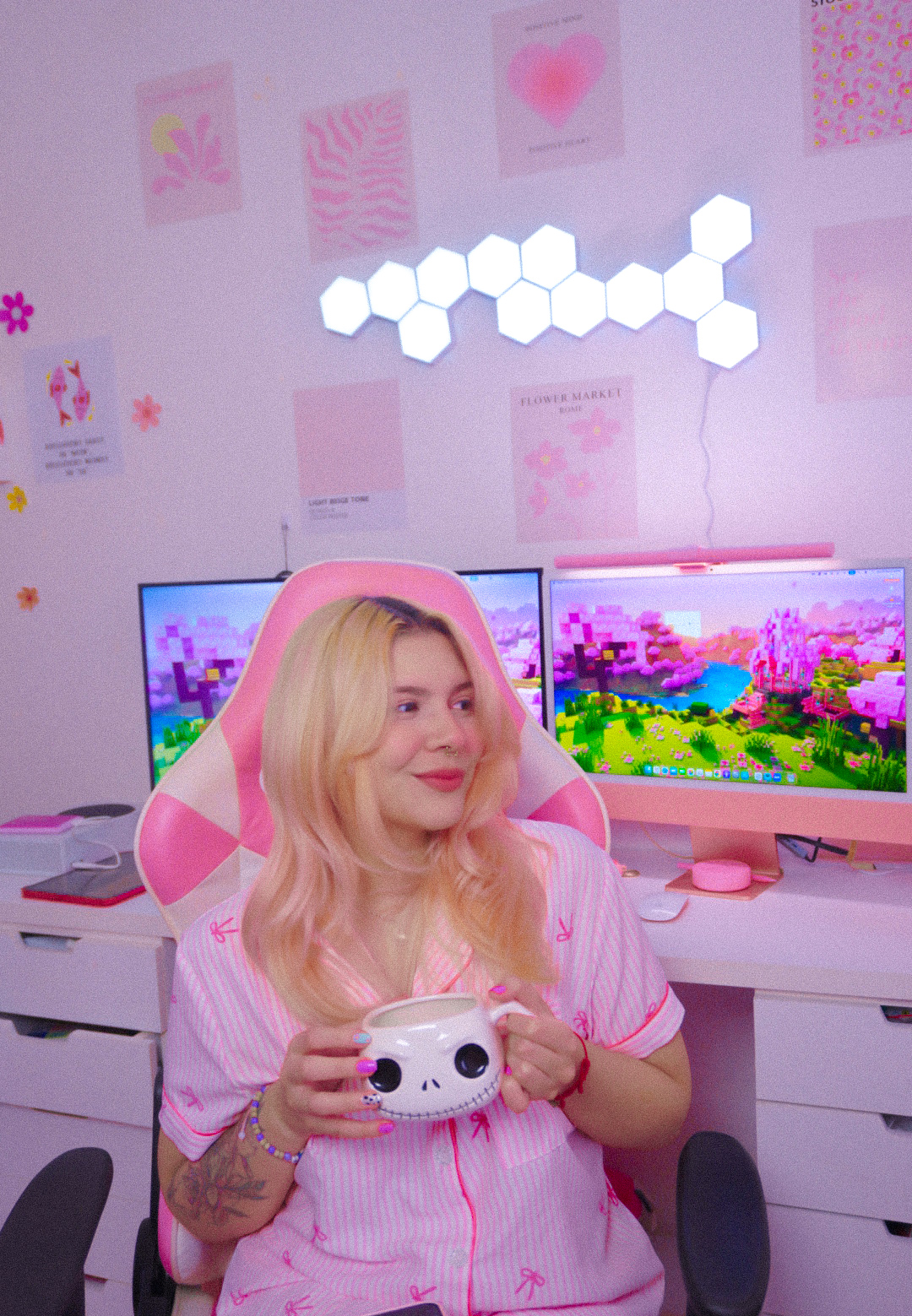 Andrea Garcia, creator of My Pink Korner, holding a mug in front of her pink gaming desk
